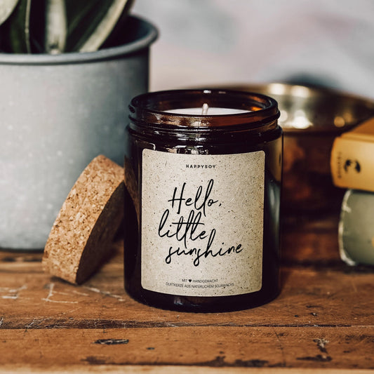Scented candle with inscription 'Hello little sunshine'